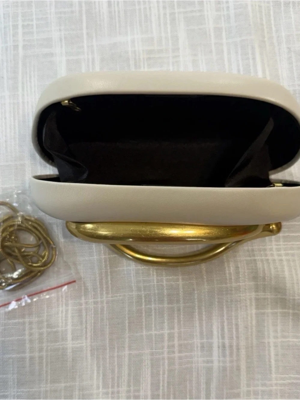 Elegant Cream Clutch with Statement Gold Handle